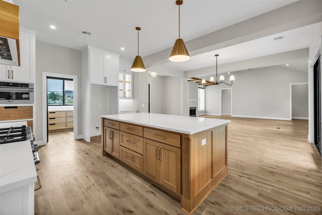 6364 N Blue Sage Dr, Owasso, OK 74055 - kitchen featuring light wood finished floors, white cabinetry, a chandelier, recessed lighting, and hanging light fixtures