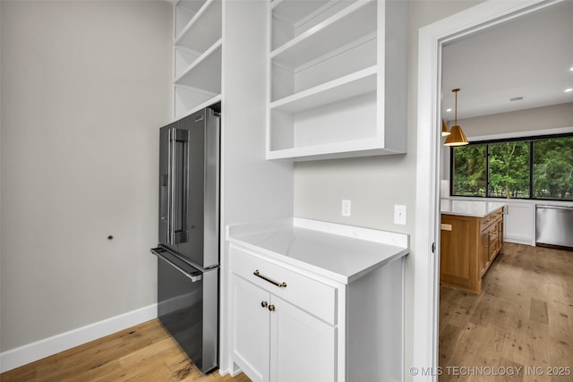 6364 N Blue Sage Dr, Owasso, OK 74055 - kitchen with stainless steel appliances, light wood-style flooring, white cabinets, open shelves, and light countertops