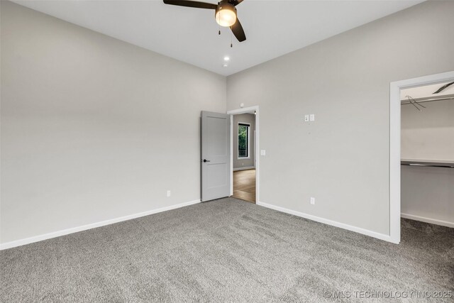 6364 N Blue Sage Dr, Owasso, OK 74055 - unfurnished bedroom featuring carpet floors, a walk in closet, a ceiling fan, and a closet
