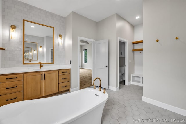 6364 N Blue Sage Dr, Owasso, OK 74055 - bathroom featuring a freestanding bath, vanity, tile patterned flooring, and recessed lighting