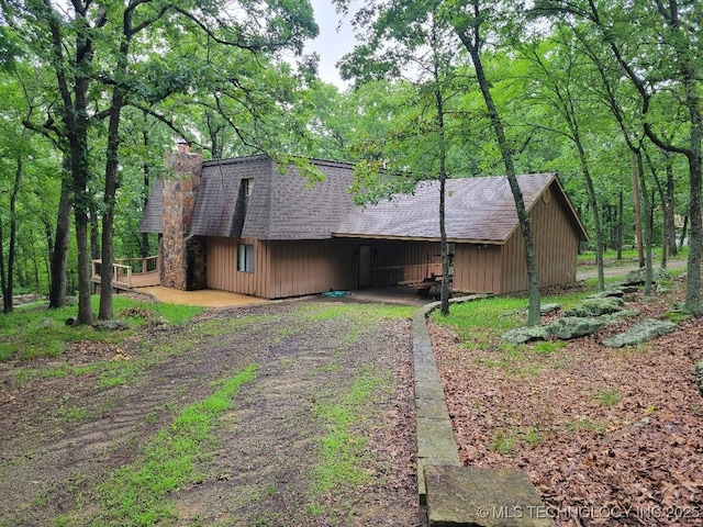 1296 Robin Hood Rd, Eufaula, OK 74432 - view of front of house with a chimney, a shingled roof, and dirt driveway