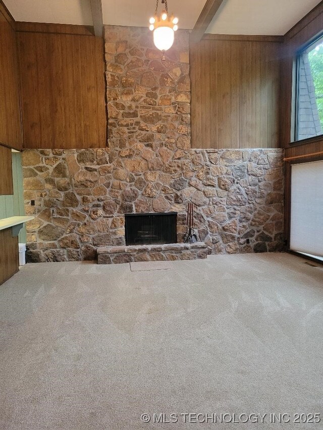 1296 Robin Hood Rd, Eufaula, OK 74432 - unfurnished living room with beam ceiling, wood walls, carpet, and a stone fireplace