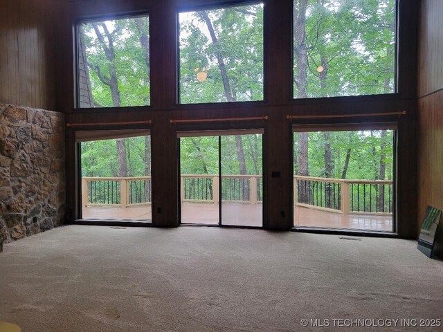 1296 Robin Hood Rd, Eufaula, OK 74432 - unfurnished living room with carpet floors and wood walls