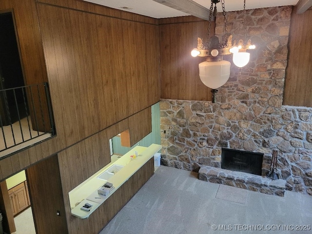 1296 Robin Hood Rd, Eufaula, OK 74432 - carpeted living room featuring wooden walls, a chandelier, and a stone fireplace