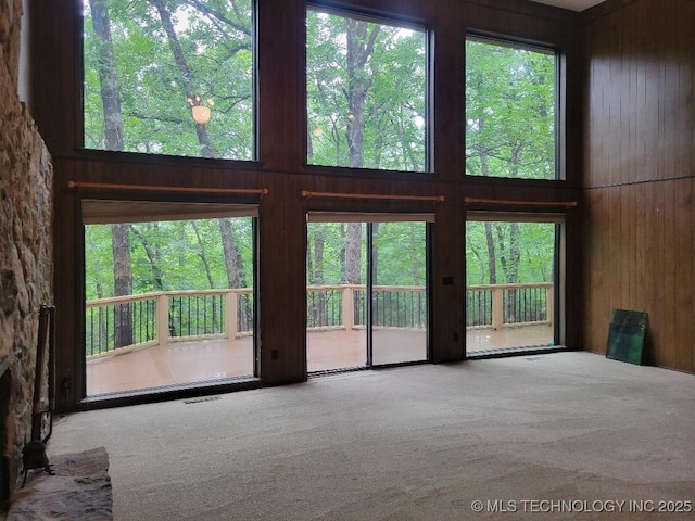 1296 Robin Hood Rd, Eufaula, OK 74432 - unfurnished living room featuring carpet flooring and wood walls