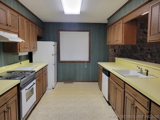 1296 Robin Hood Rd, Eufaula, OK 74432 - kitchen featuring white appliances, under cabinet range hood, light countertops, light flooring, and wood walls