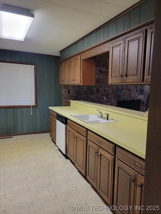 1296 Robin Hood Rd, Eufaula, OK 74432 - kitchen featuring white dishwasher, light countertops, wooden walls, and light flooring