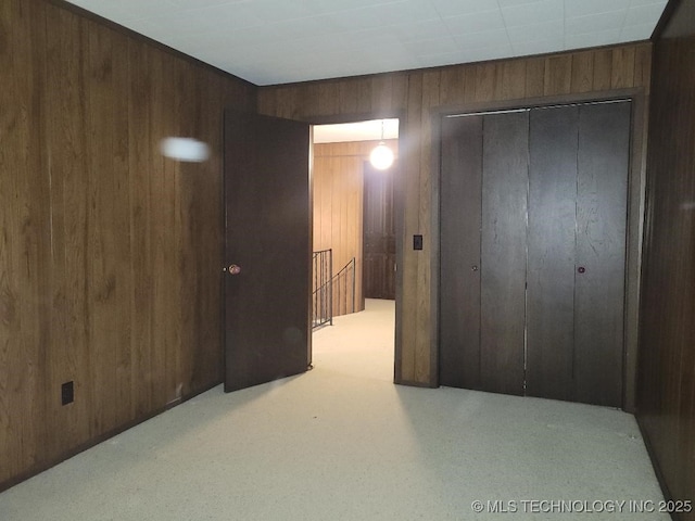 1296 Robin Hood Rd, Eufaula, OK 74432 - unfurnished bedroom featuring wooden walls, a closet, and light carpet