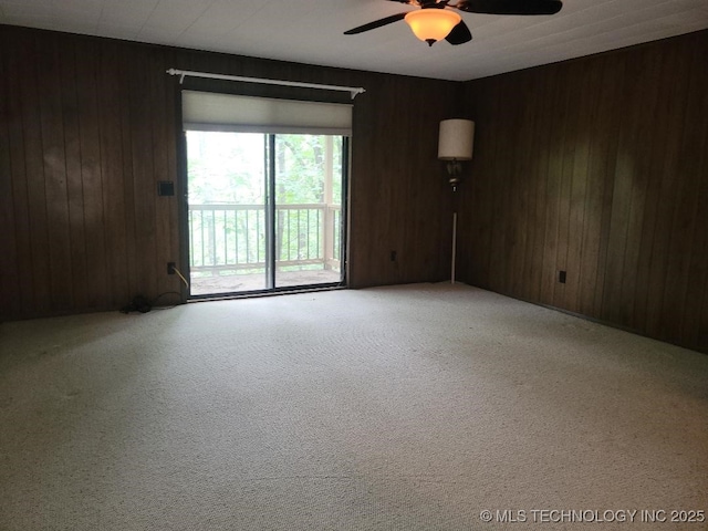 1296 Robin Hood Rd, Eufaula, OK 74432 - carpeted empty room with ceiling fan and wood walls