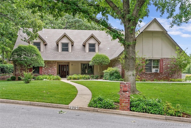 8609 S Joplin Ave, Tulsa, OK 74137 - view of front of property featuring brick siding, a front yard, a shingled roof, board and batten siding, and cooling unit