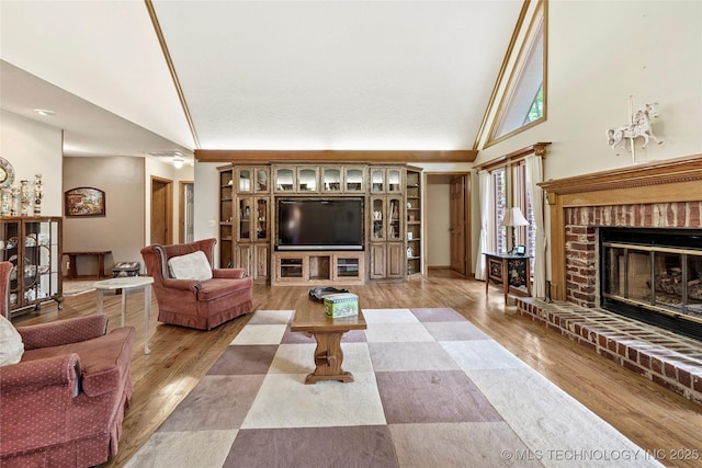 8609 S Joplin Ave, Tulsa, OK 74137 - living room featuring high vaulted ceiling, a fireplace, and light wood finished floors
