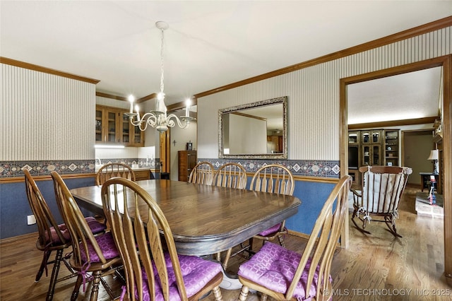 8609 S Joplin Ave, Tulsa, OK 74137 - dining space with wallpapered walls, crown molding, wood finished floors, and a chandelier