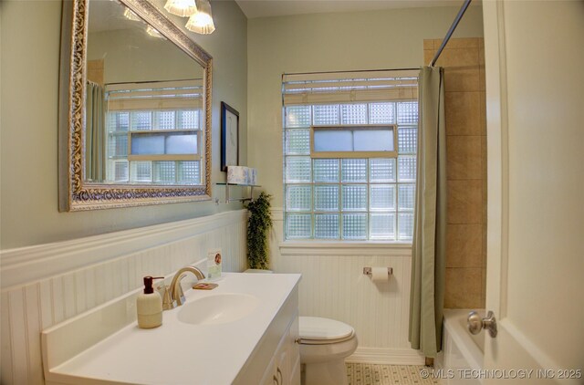 2328 S Delaware Ct, Tulsa, OK 74114 - full bath with wainscoting, vanity, shower / bath combo, and tile patterned flooring