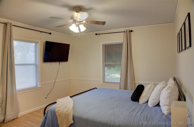 2328 S Delaware Ct, Tulsa, OK 74114 - bedroom featuring multiple windows, wood finished floors, and ceiling fan
