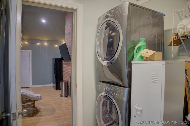2328 S Delaware Ct, Tulsa, OK 74114 - washroom with estacked washer and dryer and wood finished floors