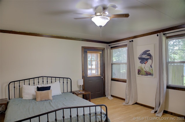 2328 S Delaware Ct, Tulsa, OK 74114 - bedroom with light wood-style flooring, multiple windows, and ceiling fan