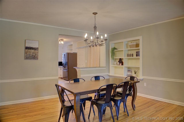 2328 S Delaware Ct, Tulsa, OK 74114 - dining room with a chandelier, light wood-style floors, and crown molding