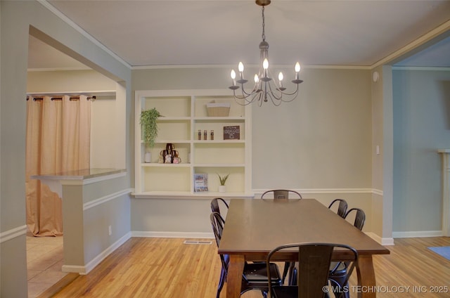 2328 S Delaware Ct, Tulsa, OK 74114 - dining space with a chandelier, wood finished floors, and crown molding