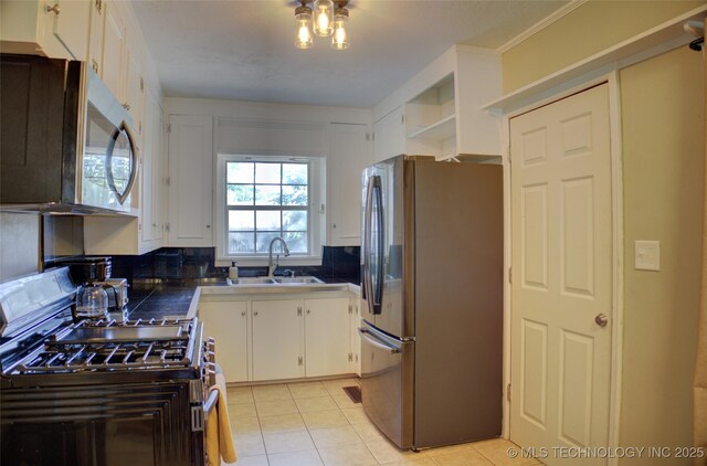 2328 S Delaware Ct, Tulsa, OK 74114 - kitchen with stainless steel appliances, white cabinets, light tile patterned floors, backsplash, and dark countertops