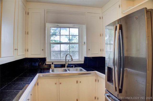 2328 S Delaware Ct, Tulsa, OK 74114 - kitchen featuring stainless steel fridge, white cabinets, and decorative backsplash