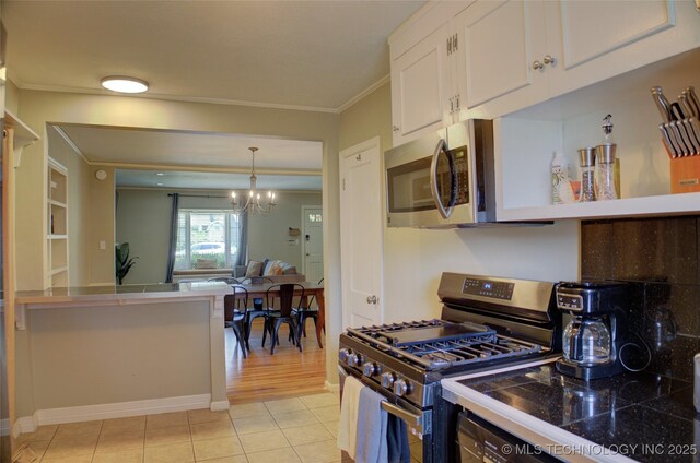 2328 S Delaware Ct, Tulsa, OK 74114 - kitchen featuring appliances with stainless steel finishes, ornamental molding, white cabinetry, a chandelier, and light tile patterned flooring