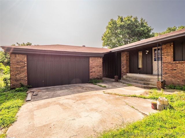 1015 Diehl Ln, Hartshorne, OK 74547 - view of front of property with brick siding, a garage, and concrete driveway