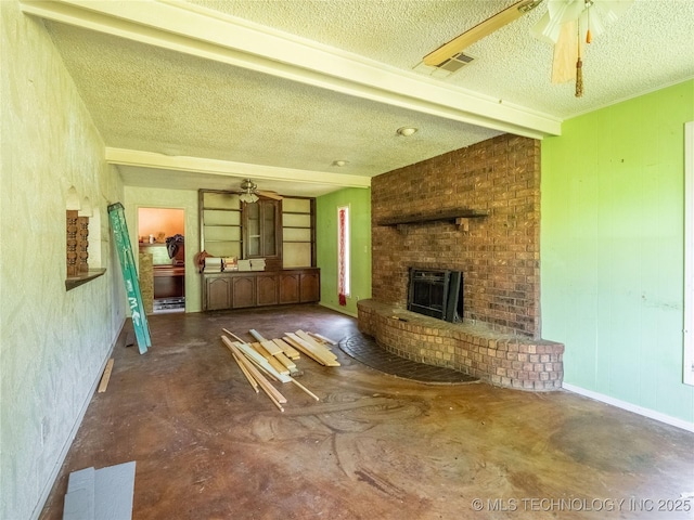 1015 Diehl Ln, Hartshorne, OK 74547 - unfurnished living room featuring a ceiling fan, a textured ceiling, a brick fireplace, and concrete flooring