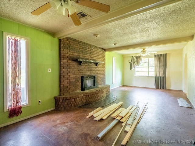 1015 Diehl Ln, Hartshorne, OK 74547 - unfurnished living room with ceiling fan, a brick fireplace, a textured ceiling, and concrete flooring