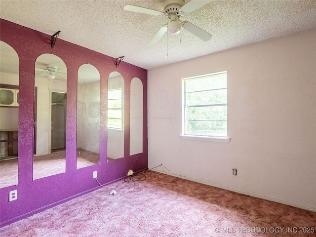 1015 Diehl Ln, Hartshorne, OK 74547 - carpeted empty room featuring a ceiling fan, arched walkways, and a textured ceiling