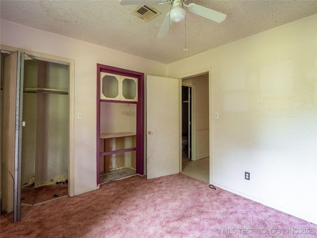 1015 Diehl Ln, Hartshorne, OK 74547 - unfurnished bedroom with carpet floors, a closet, a textured ceiling, and a ceiling fan