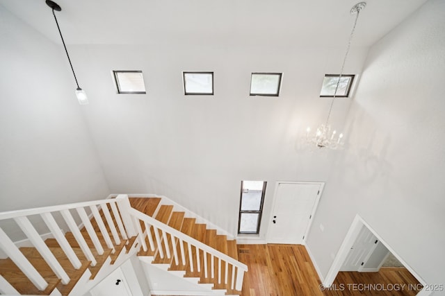 7927 S 86th E Ave, Tulsa, OK 74133 - stairs with a high ceiling, wood finished floors, and a chandelier