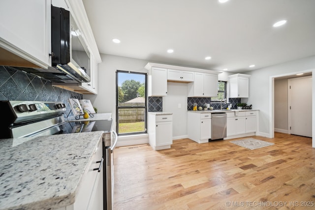7927 S 86th E Ave, Tulsa, OK 74133 - kitchen with appliances with stainless steel finishes, white cabinetry, backsplash, light wood finished floors, and recessed lighting