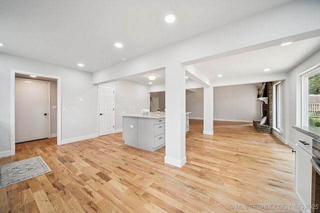 7927 S 86th E Ave, Tulsa, OK 74133 - basement with light wood finished floors, recessed lighting, and a brick fireplace