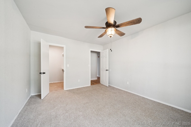 7927 S 86th E Ave, Tulsa, OK 74133 - unfurnished bedroom featuring light carpet, a spacious closet, and a ceiling fan