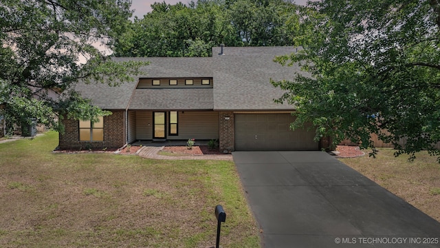 7927 S 86th E Ave, Tulsa, OK 74133 - view of front of house with roof with shingles, an attached garage, driveway, a front yard, and brick siding