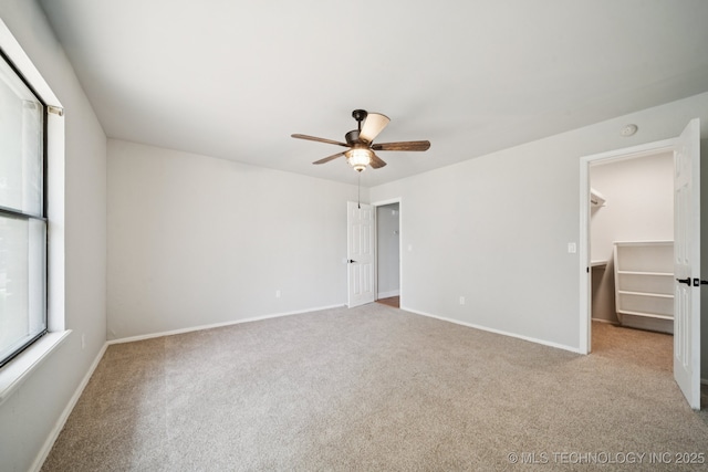 7927 S 86th E Ave, Tulsa, OK 74133 - unfurnished bedroom featuring carpet floors, a spacious closet, and a ceiling fan