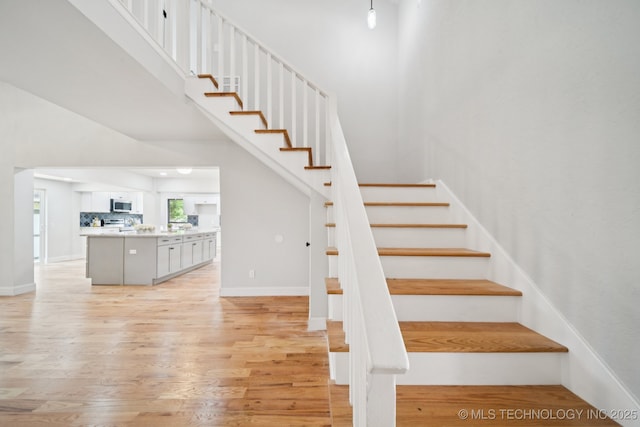 7927 S 86th E Ave, Tulsa, OK 74133 - stairs featuring a towering ceiling and wood finished floors