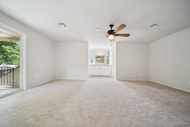 7927 S 86th E Ave, Tulsa, OK 74133 - unfurnished living room with plenty of natural light, light carpet, and ceiling fan