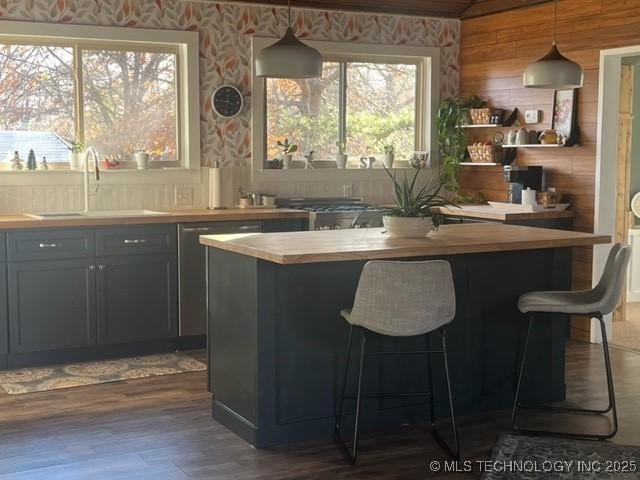 251 Greer Rd, Longtown, OK 74432 - bar with wallpapered walls, hanging light fixtures, dark wood-style flooring, and stainless steel dishwasher