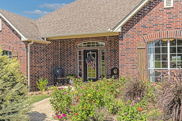 330 Loma Vista Ln, Skiatook, OK 74070 - view of exterior entry with a shingled roof and brick siding
