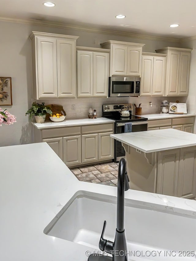 330 Loma Vista Ln, Skiatook, OK 74070 - kitchen featuring appliances with stainless steel finishes, light countertops, crown molding, backsplash, and recessed lighting
