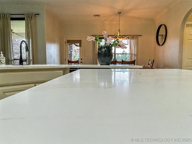 330 Loma Vista Ln, Skiatook, OK 74070 - kitchen view of a chandelier, hanging light fixtures, and light stone countertops