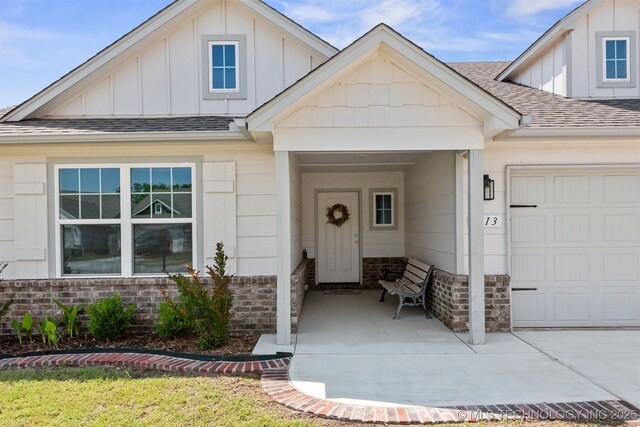 1813 E Van Buren Pl, Broken Arrow, OK 74011 - view of front of home with board and batten siding, a shingled roof, a garage, and brick siding