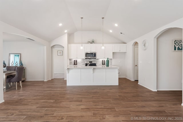 1813 E Van Buren Pl, Broken Arrow, OK 74011 - kitchen with stainless steel appliances, arched walkways, dark wood-type flooring, white cabinetry, and decorative backsplash