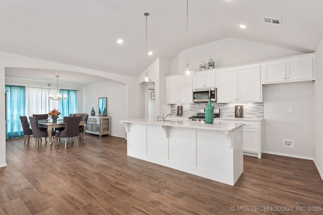1813 E Van Buren Pl, Broken Arrow, OK 74011 - kitchen with stainless steel microwave, range, lofted ceiling, light countertops, and white cabinetry
