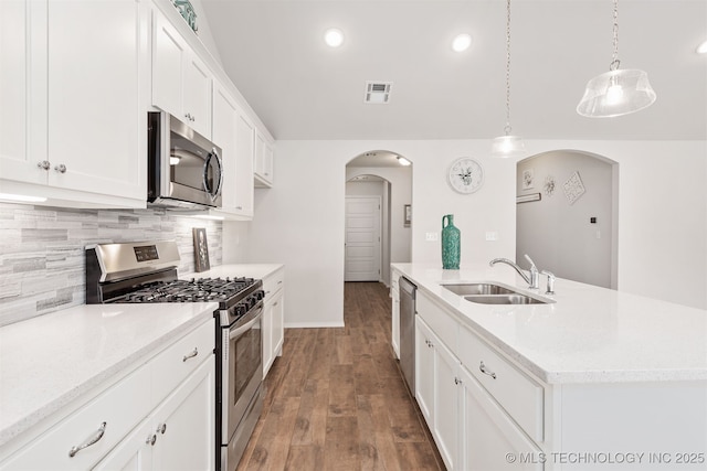 1813 E Van Buren Pl, Broken Arrow, OK 74011 - kitchen with stainless steel appliances, arched walkways, backsplash, white cabinets, and recessed lighting
