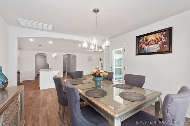 1813 E Van Buren Pl, Broken Arrow, OK 74011 - dining area with arched walkways, a chandelier, dark wood-style floors, and recessed lighting