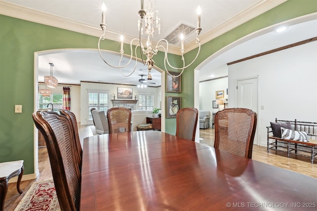 4733 S 167th E Pl, Tulsa, OK 74134 - dining space with crown molding, arched walkways, and wood finished floors