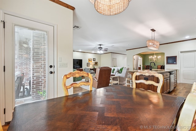 4733 S 167th E Pl, Tulsa, OK 74134 - dining area featuring a chandelier, arched walkways, crown molding, recessed lighting, and a ceiling fan