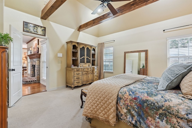 4733 S 167th E Pl, Tulsa, OK 74134 - bedroom featuring light carpet, beam ceiling, a fireplace, ceiling fan, and high vaulted ceiling